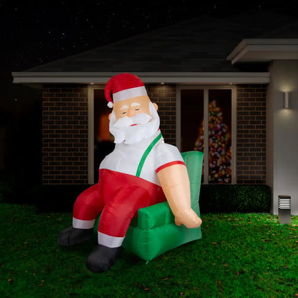 Inflatable Santa napping in a green armchair, part of the 1.9M Couch Potato Santa Christmas Inflatable collection