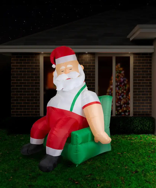 Inflatable Santa napping in a green armchair, part of the 1.9M Couch Potato Santa Christmas Inflatable collection