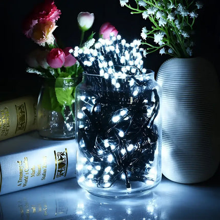 Illuminated string lights inside a glass jar for Christmas decoration showing cool white LED fairy lights