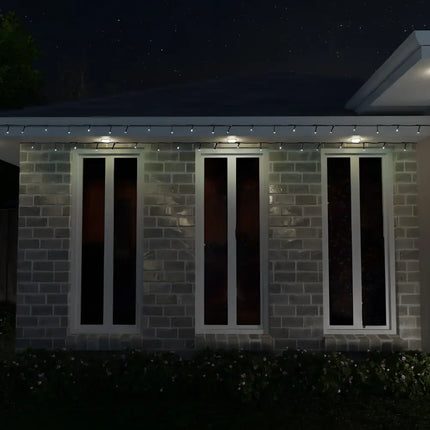 Brick building with three windows illuminated by multicolor 1000 LED Fairy Lights