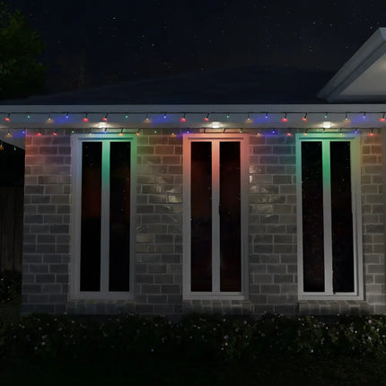 Brick building illuminated with colorful holiday lights from 1000 LED Fairy Lights