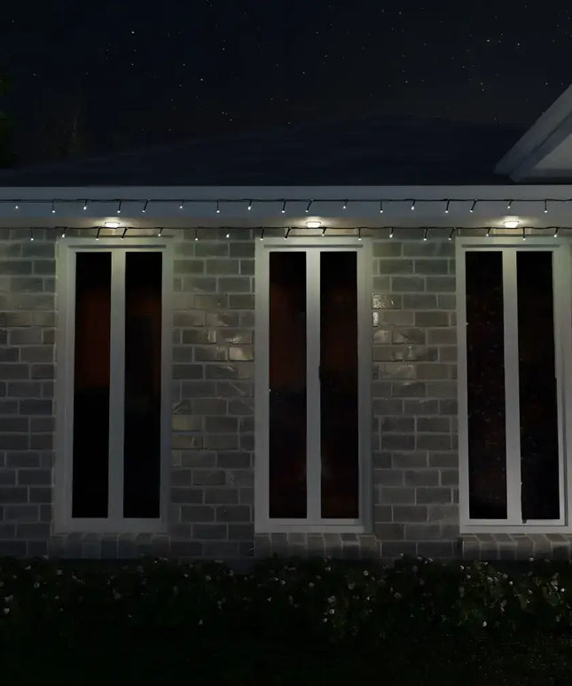 Brick building with three windows illuminated by 1000 LED Fairy Lights in cool white
