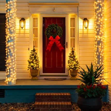 Festive holiday home entrance decorated with 1000 Solar LED Fairy Lights in warm white