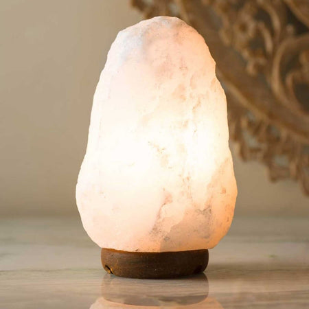 Elegant white Himalayan salt lamp on a sturdy timber base for home decor.