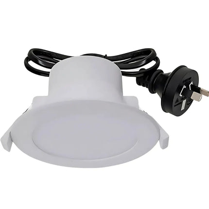White light fixture with black cord and plug on a white background
