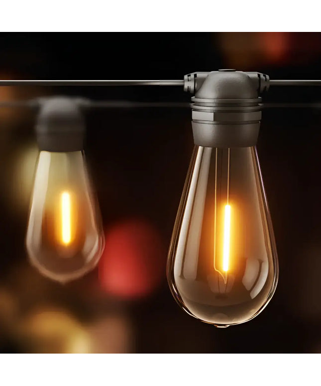 Illuminated vintage-style string lights from the 17m Black Solar Festoon String Lights with 15 Bulb Plug in Kit