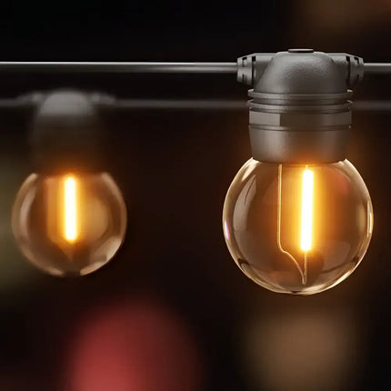 Illuminated string of globe lights for outdoor decoration with 17-meter Black Solar Festoon String Lights and 15 Bulb Plug-in Kit