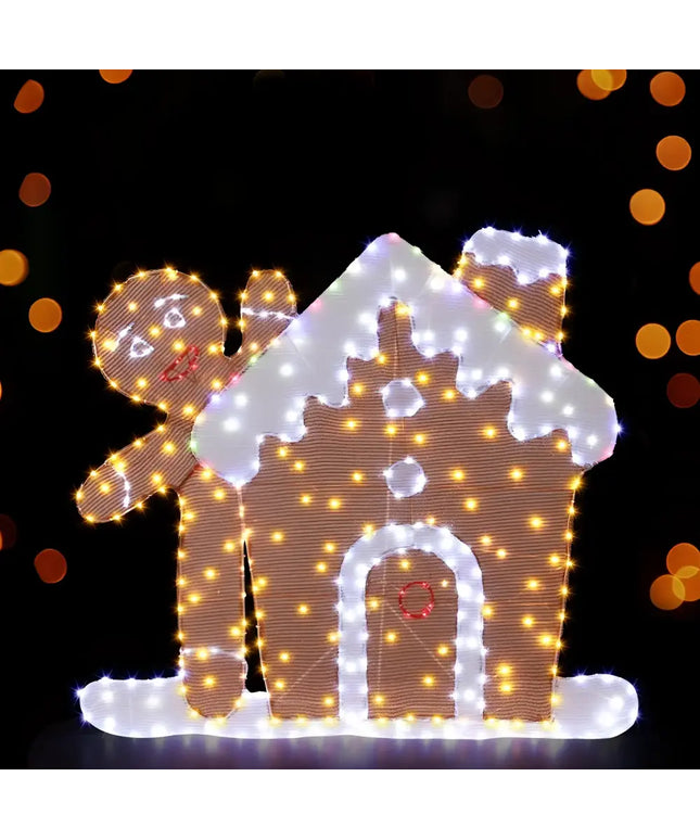 Illuminated gingerbread house and man decoration for Christmas holiday festive display
