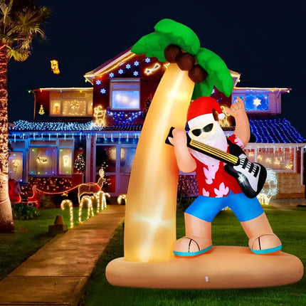 Inflatable Santa playing guitar under a palm tree illuminated with LED lights for Christmas decor