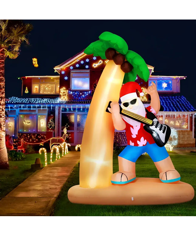 Inflatable Santa playing guitar under a palm tree illuminated with LED lights for Christmas decor