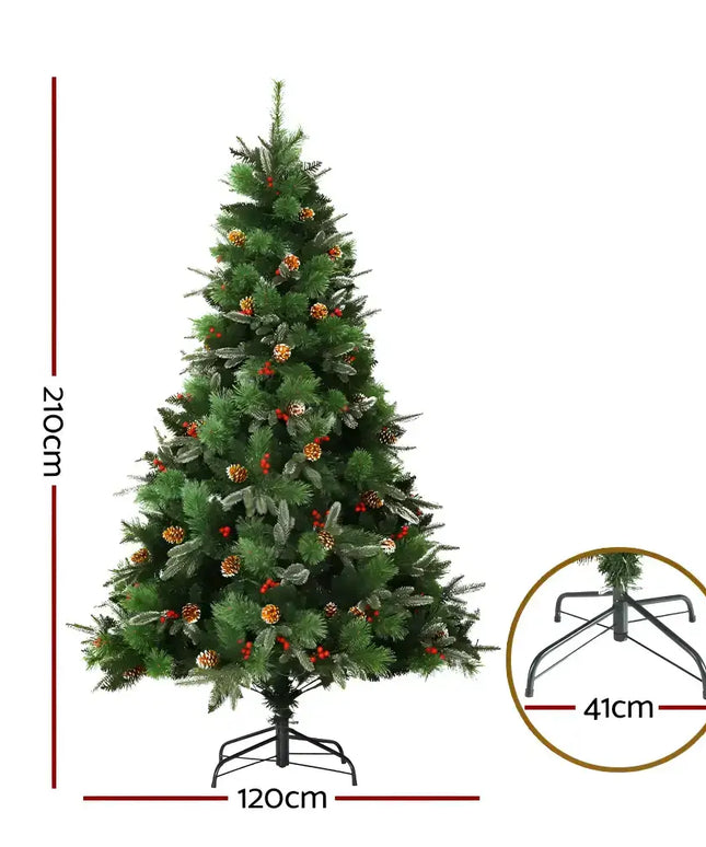 Decorated artificial Christmas tree with pine cones, red berries, and prelit warm LED lights