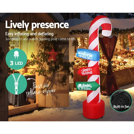 Inflatable candy cane signpost for Christmas decorations illuminating outdoor festive displays