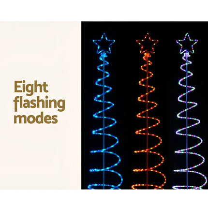 Illuminated spiral Christmas trees with LED solar motif lights for festive decoration