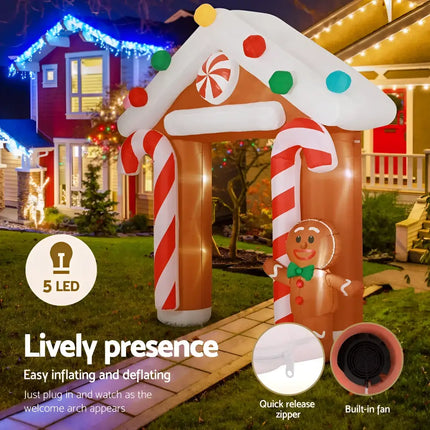 Inflatable gingerbread house archway illuminated for Christmas holiday decoration