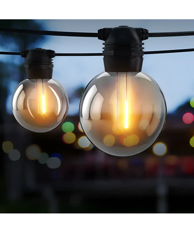 Illuminated globe string lights on black solar festoon string with 20 bulbs and plug-in kit