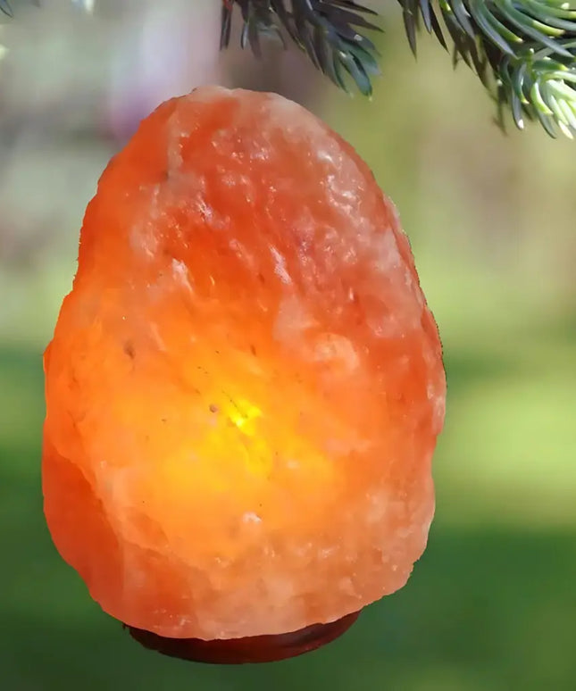 Authentic natural-shaped Himalayan salt lamp with a soft amber glow.