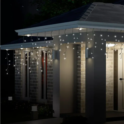 Illuminated multicolor 300 LED icicle flashing lights on house exterior for festive decoration