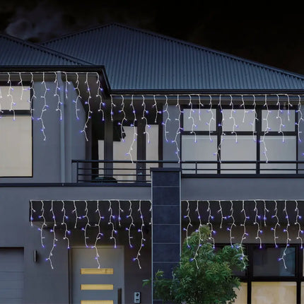 House decorated with colorful 480 LEDs Snowing Icicle Lights for festive illumination