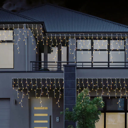 Illuminated multicolor 480 LEDs snowing icicle lights decorating a house during night