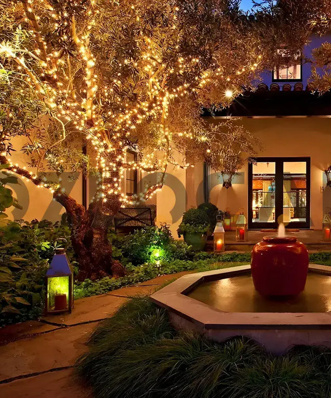 Illuminated outdoor garden decorated with 500 Solar LED Fairy Lights in warm white and multicolor