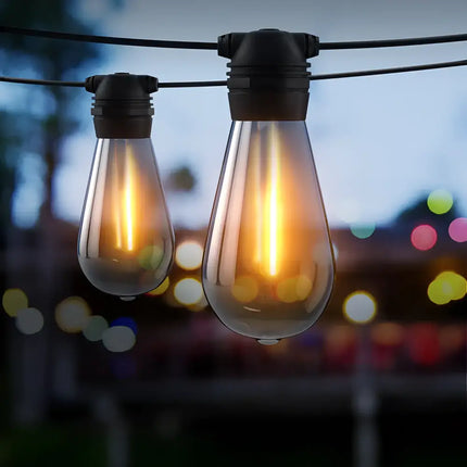 Black Solar Festoon String Lights with 50 Bulb Plug-in Kit hanging for outdoor ambiance