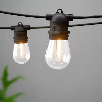 Hanging string lights with clear bulbs on 59m Black Festoon String Lights with 60 Bulb Plug in Kit