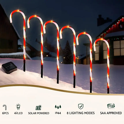Solar-powered candy cane pathway lights for festive garden decoration and illumination