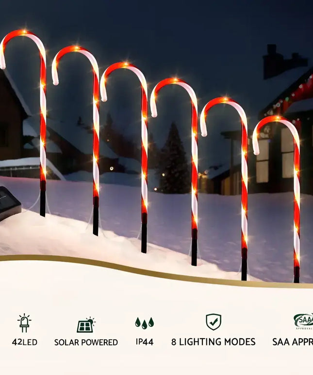 Solar-powered candy cane pathway lights for festive garden decoration and illumination