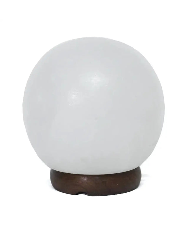 6-inch white sphere salt lamp with a smooth, rounded design and timber base, softly glowing in a serene setting.