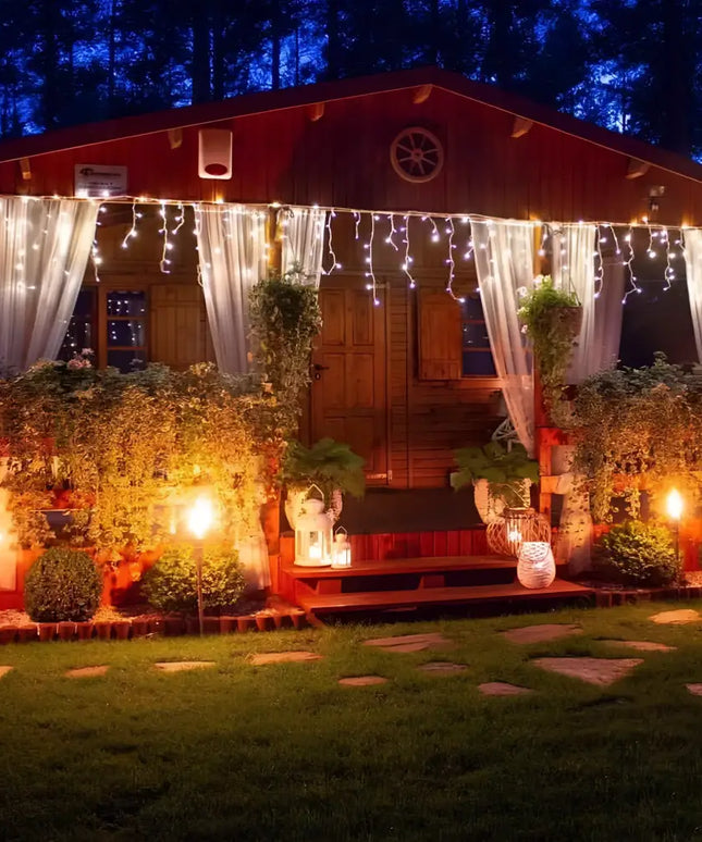 Illuminated cozy cabin decorated with 600 Low Voltage Bluetooth Control LED Icicle Fairy Lights in cool white