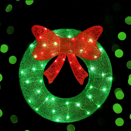 Illuminated green wreath with red bow from 60cm Green LED Motif Solar Wreath Christmas Decorations