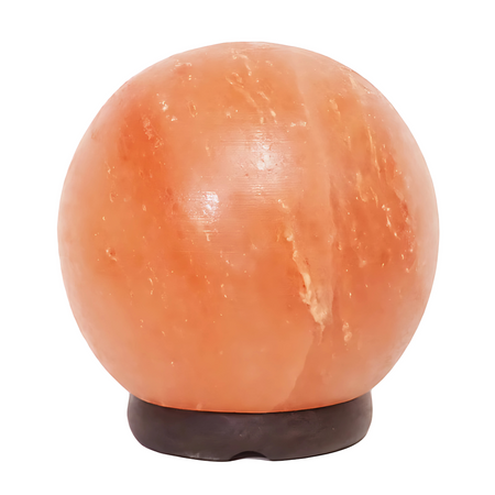 6-inch sphere Himalayan salt lamp on a timber base glowing warmly in a serene bedroom.