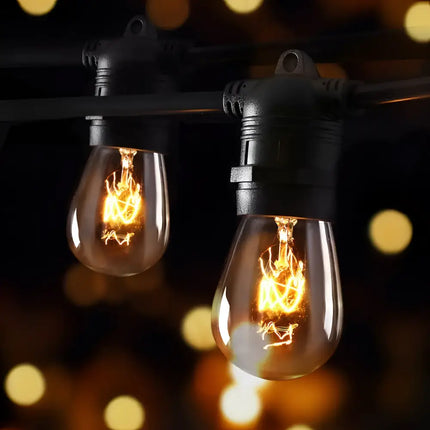 String of glowing vintage-style festoon lights from the 74m Black Festoon String Lights with 80 Bulb Plug in Kit