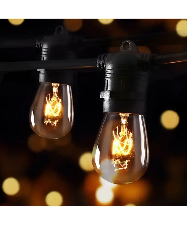 String of glowing vintage-style festoon lights from the 74m Black Festoon String Lights with 80 Bulb Plug in Kit