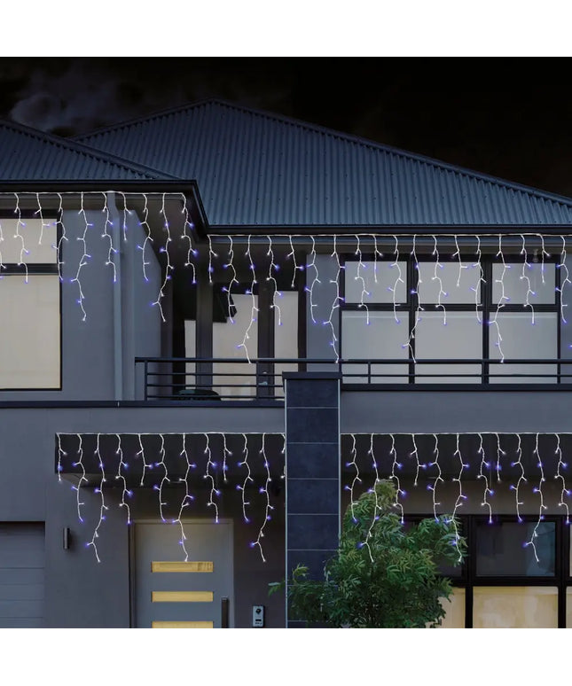 House decorated with colorful icicle lights from 960 LEDs Snowing Icicle Lights product