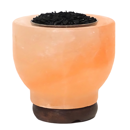 Activated coconut charcoal Himalayan salt lamp emitting a warm amber glow for air purification.