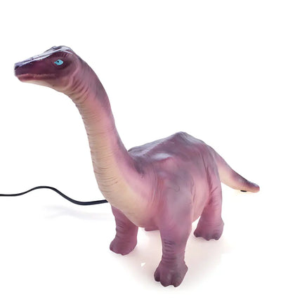 Prehistoric-themed Brachiosaurus lamp on a nightstand