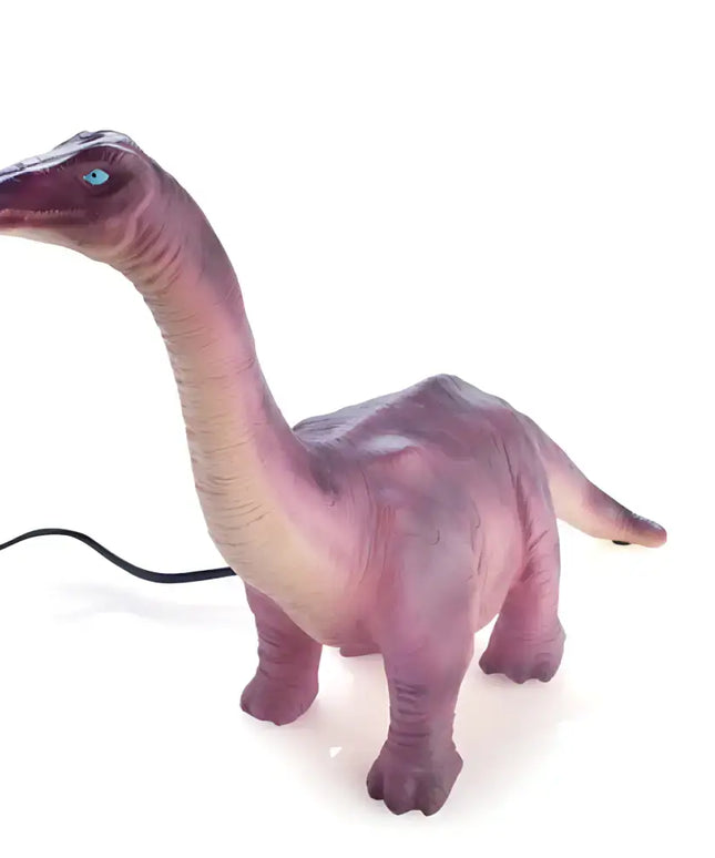 Prehistoric-themed Brachiosaurus lamp on a nightstand