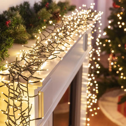 Christmas lights draped on a mantel featuring Cluster Lights 720 LEDs in six color options