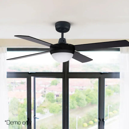 Modern ceiling fan with four wooden blades and sleek black finish