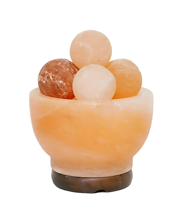 Fire bowl Himalayan salt lamp filled with glowing pink salt spheres on a timber base.