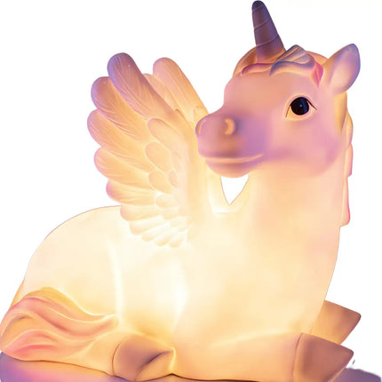Giant Unicorn Table Lamp glowing softly in a bedroom