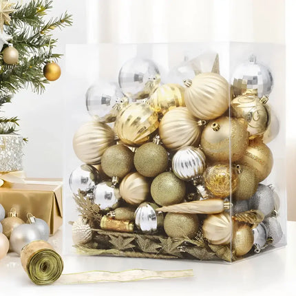 Assorted gold and silver Christmas ornaments in a clear box for holiday decoration