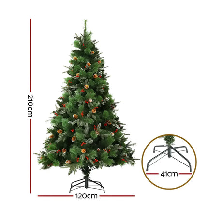 Decorated artificial Christmas tree with pine cones, red berries, and prelit warm LED lights