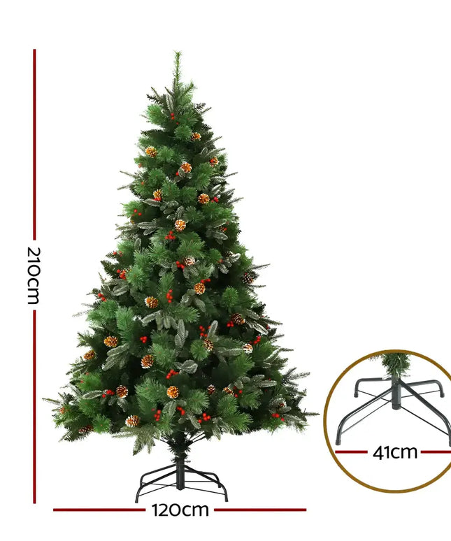 Decorated artificial Christmas tree with pine cones, red berries, and prelit warm LED lights