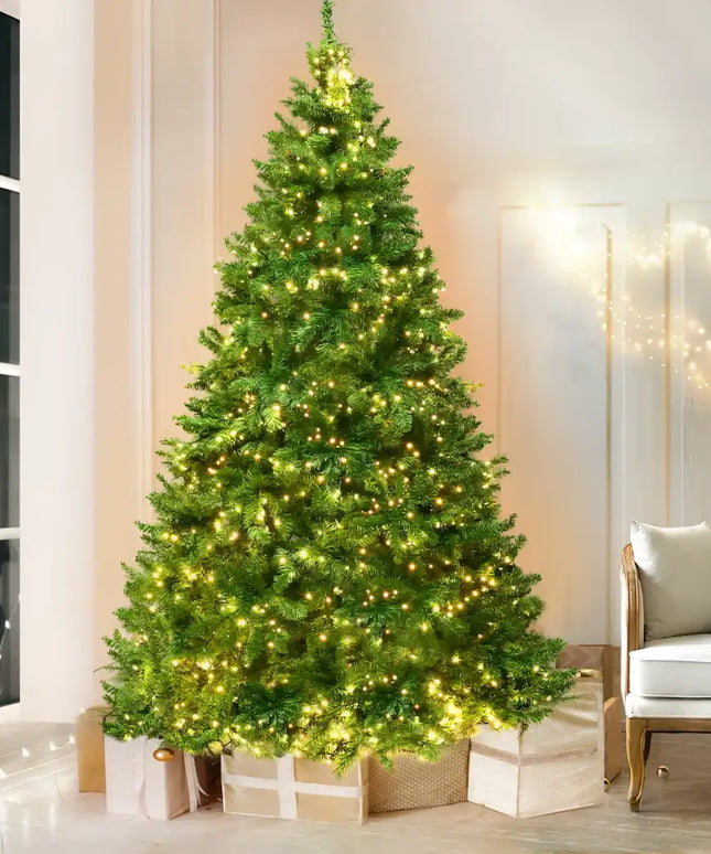 Illuminated Jingle Jollys Christmas Tree with gifts and 874 LED lights in festive setting