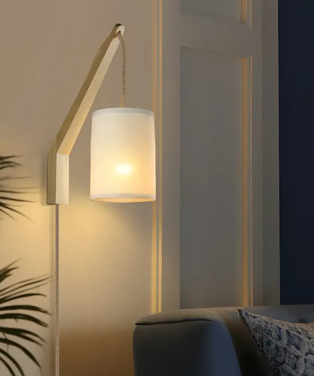 Wall-mounted Kya Wall Light with a sleek cylindrical shade for modern illumination