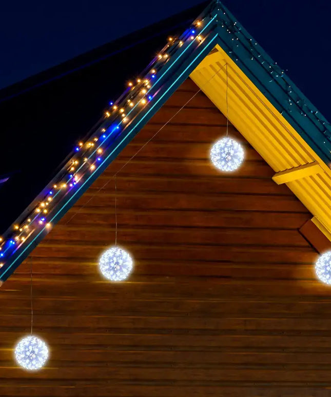 Illuminated spherical hanging LED decorations in warm and cool white for festive ambiance
