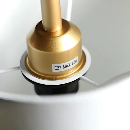 Gold lamp socket with warning label on Lexi ADELE Metal and Marble Floor Lamp