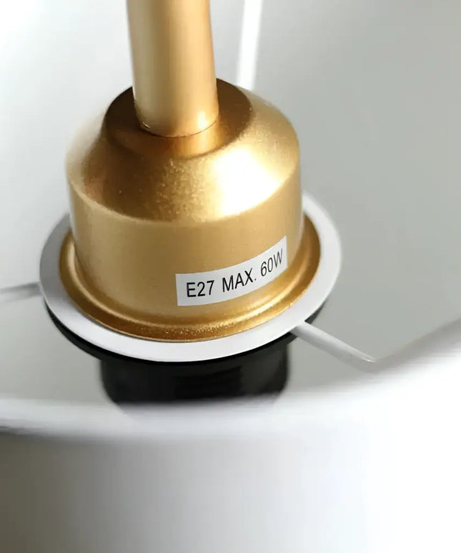 Gold lamp socket with warning label on Lexi ADELE Metal and Marble Floor Lamp